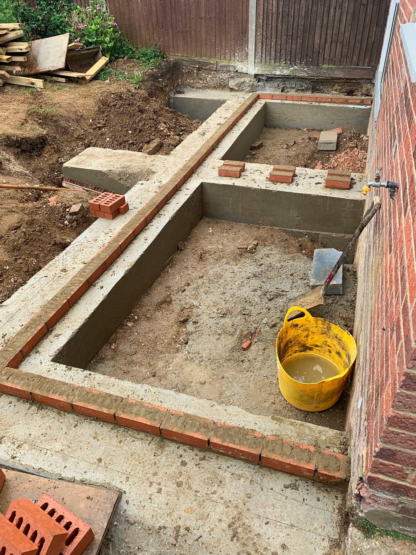 Strip foundations set out and inspected before the slab, London extension