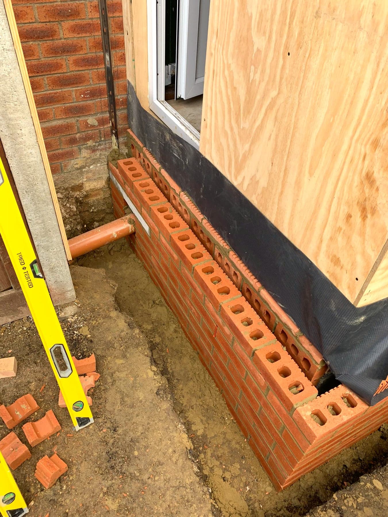 Brickwork laid off the footings with damp-proof membrane, London extension