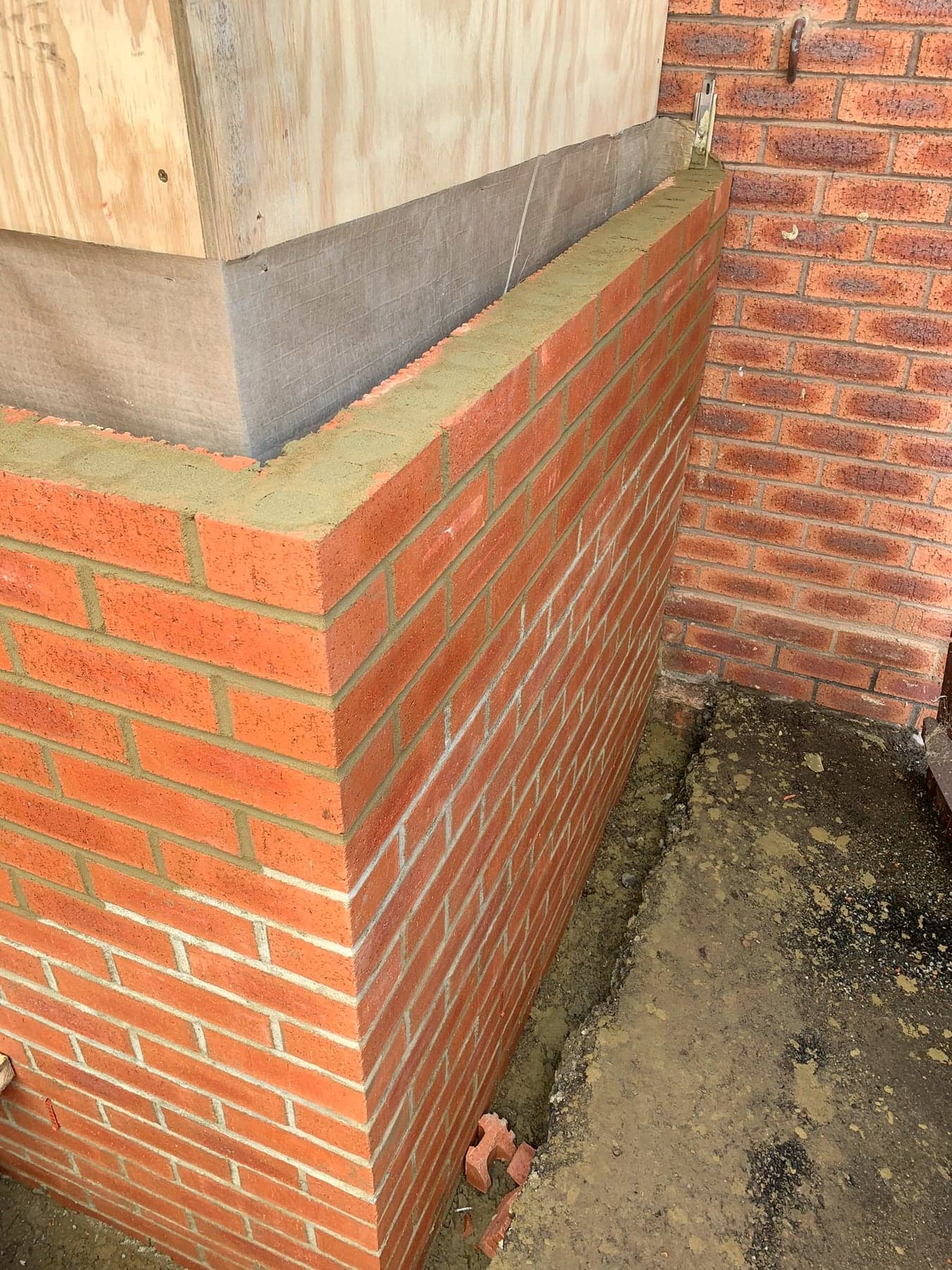 Facing brickwork corner detail with coping above, London extension