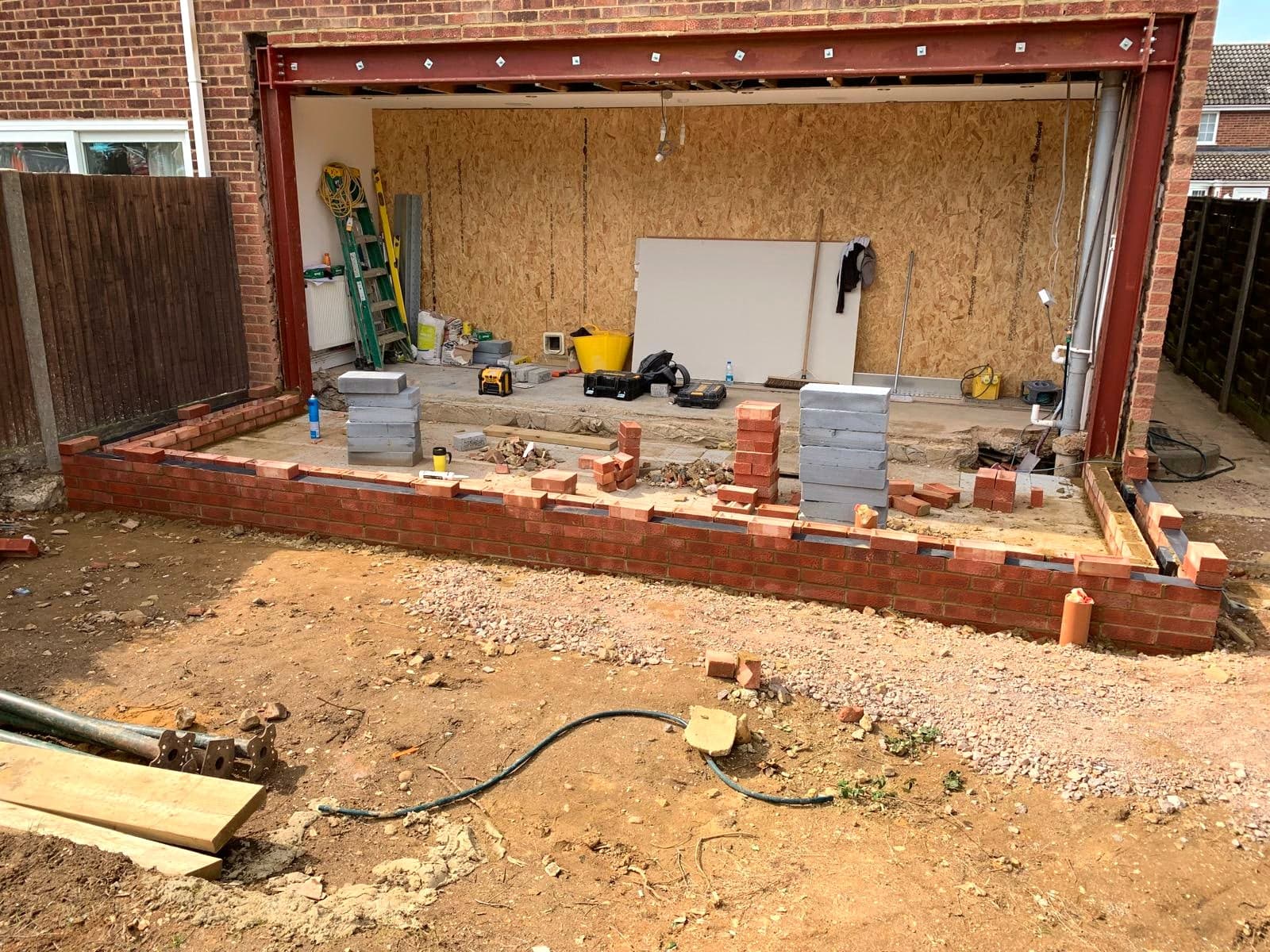 Structural steel goalpost frame installed over the new opening, London extension