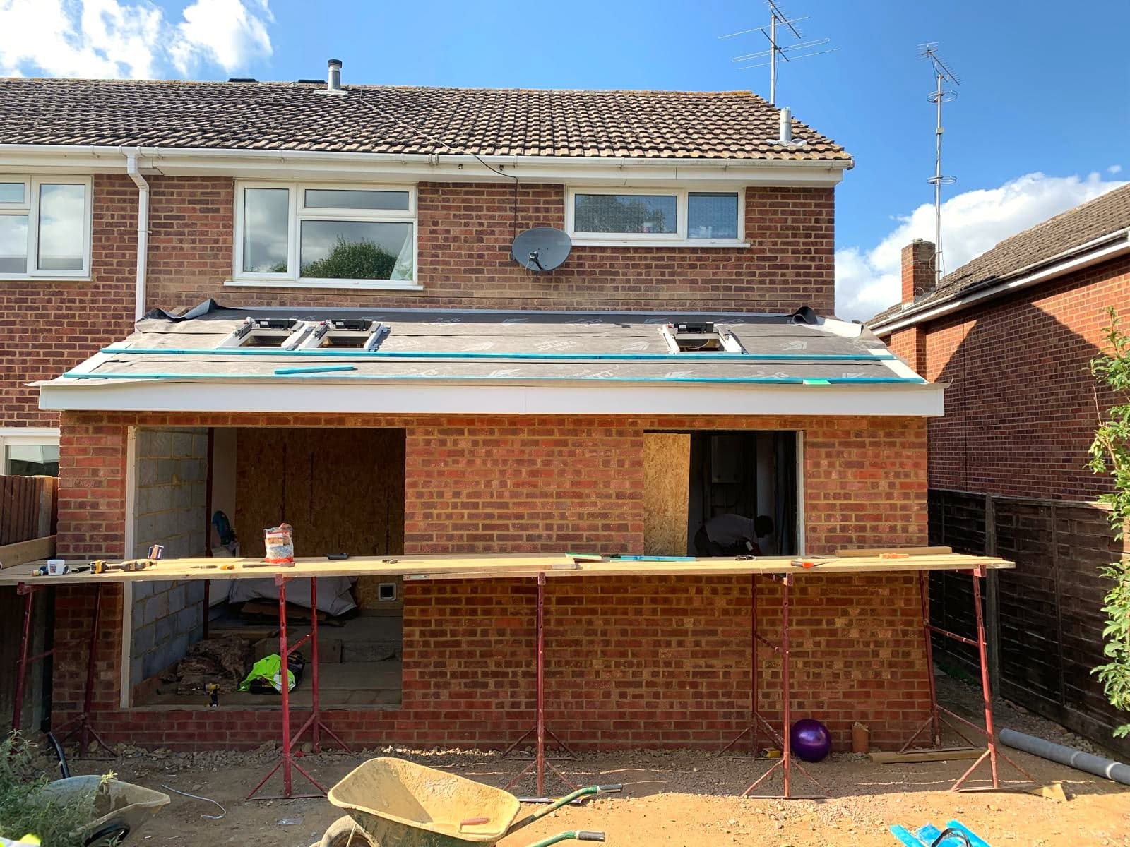Completed brick extension shell with rooflights set into the flat roof, London extension