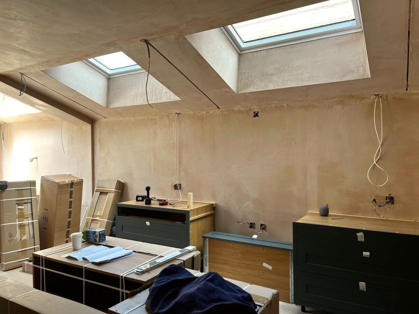 Kitchen units being fitted under new rooflights, London extension