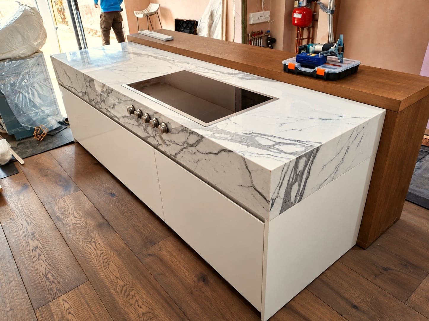 Marble-effect waterfall worktop fitted to a new kitchen island, London extension