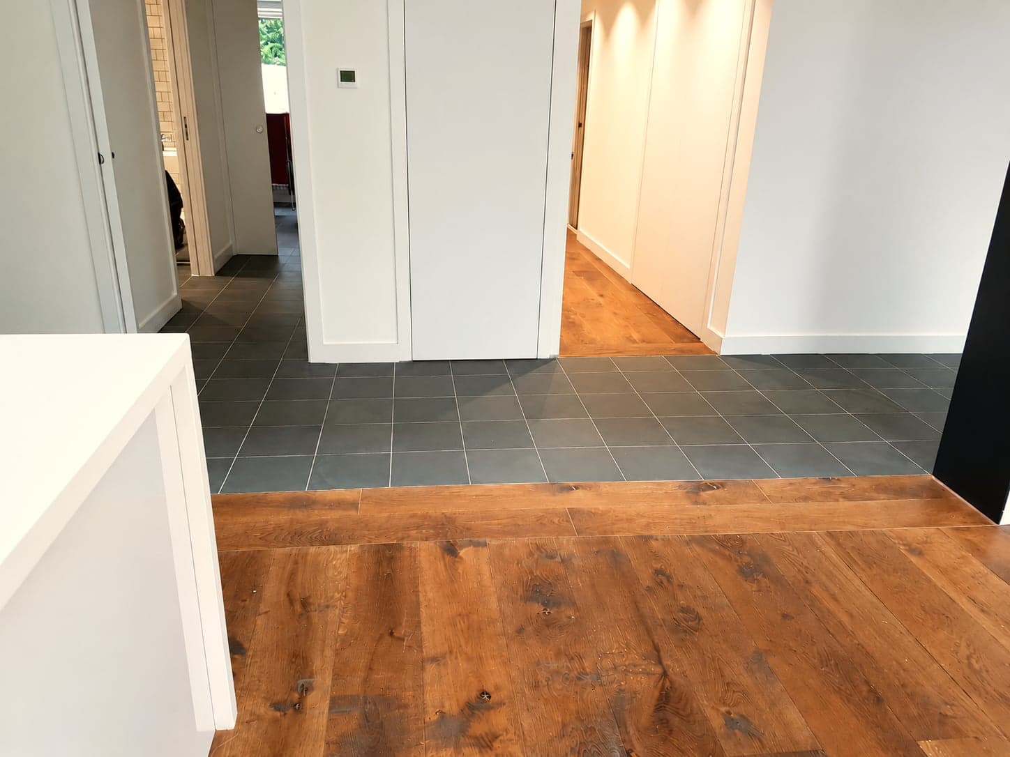 Finished hallway with tiled and oak flooring and new doors, London extension