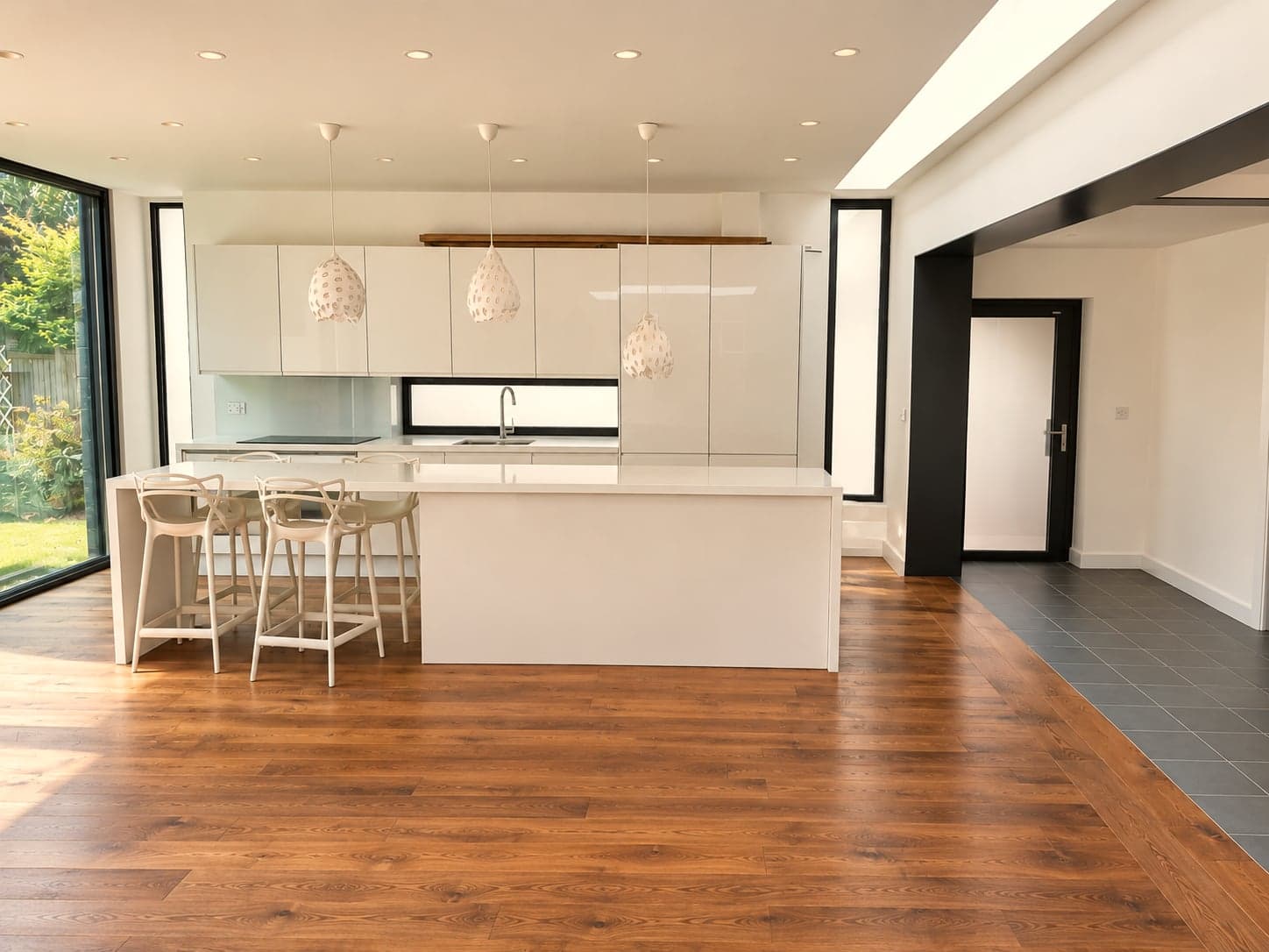 Completed open-plan kitchen with island and oak flooring, London extension