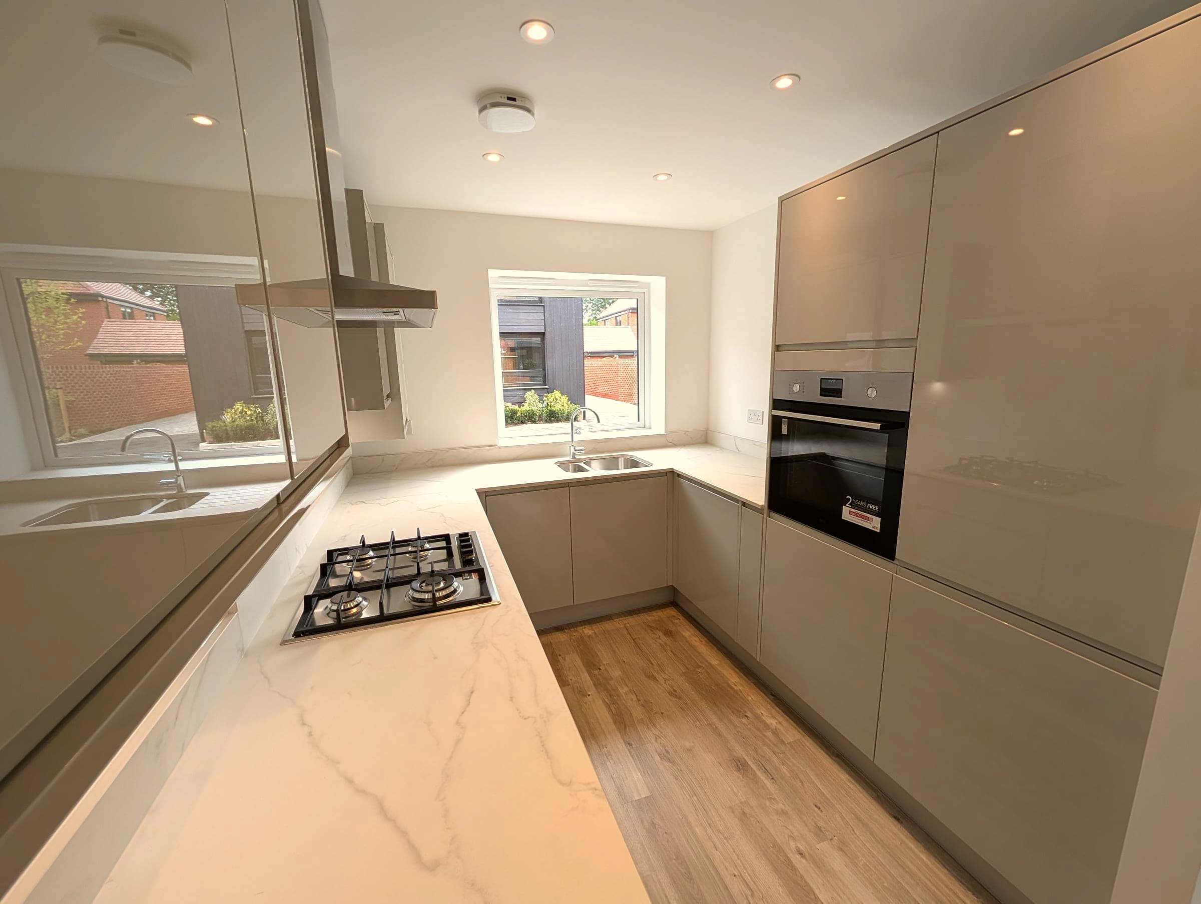 Grey gloss handleless kitchen renovation, London