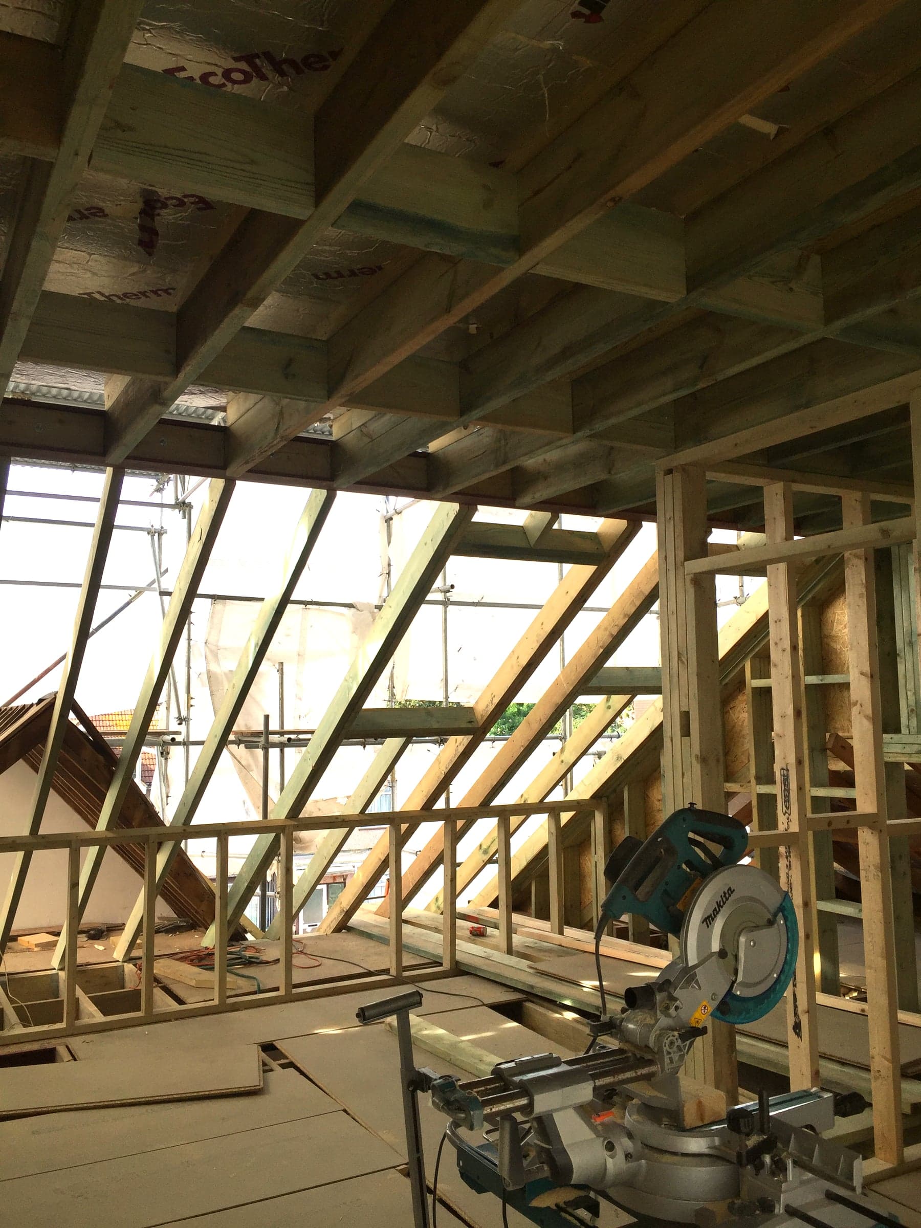 Carpenter fixing a dormer stud wall, London loft conversion