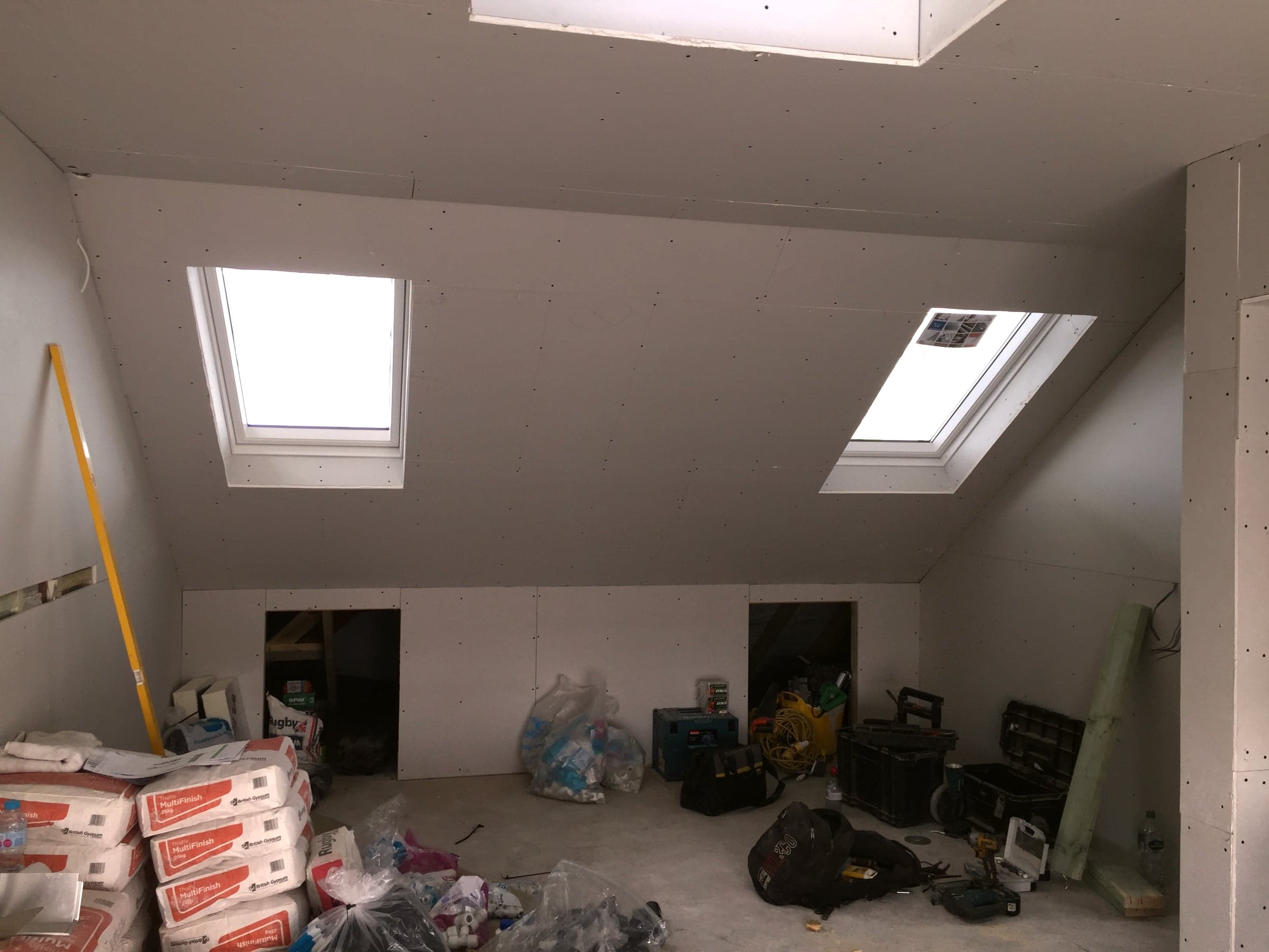 Plasterboard dressed around two skylights, London loft conversion