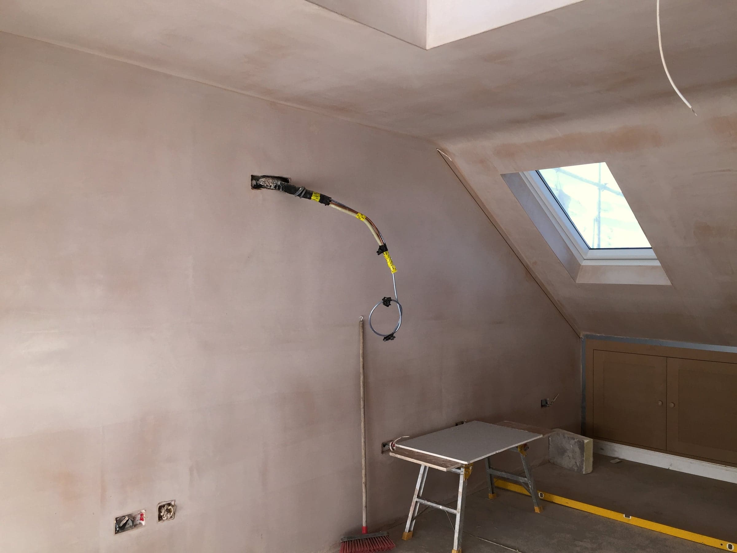 Electrical cabling chased into plaster, London loft conversion