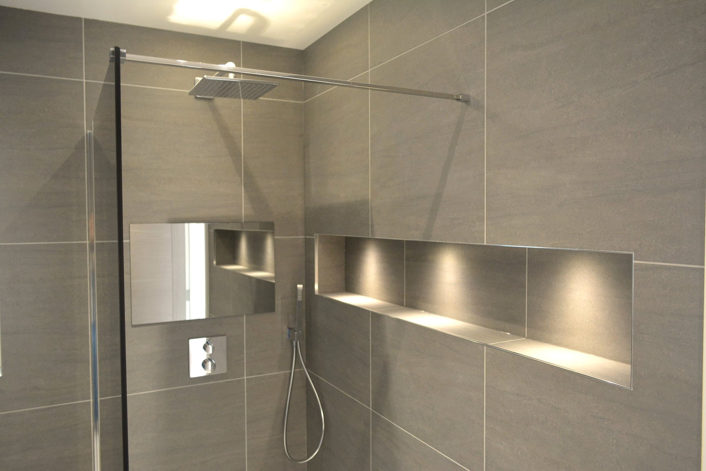 Finished walk-in shower with lit tiled niche, London loft conversion