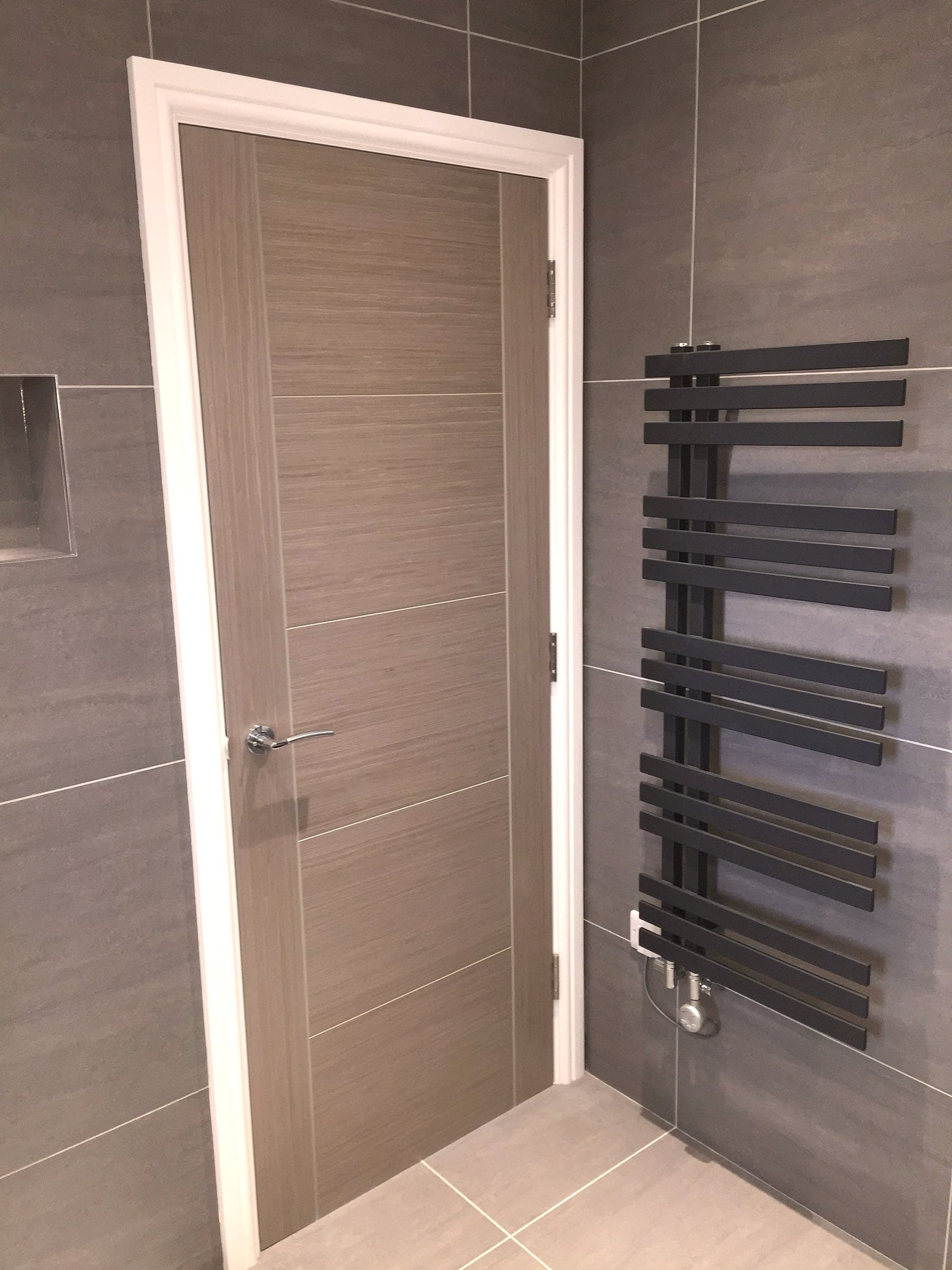 Finished loft room with sliding doors and recessed lighting, London