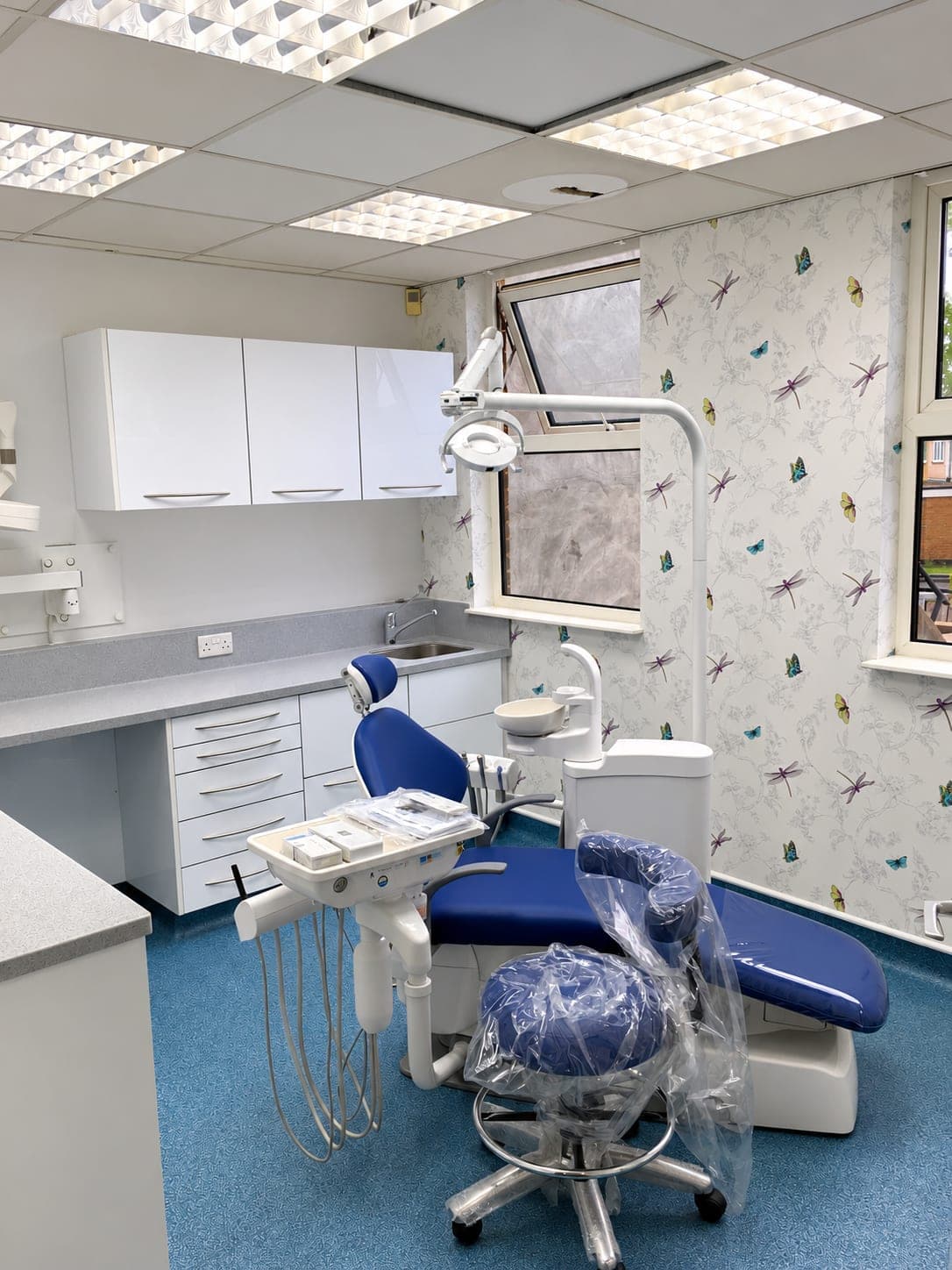 Treatment room with worktop run, drawer units and the chair still wrapped after installation, Belmont Circle HA3