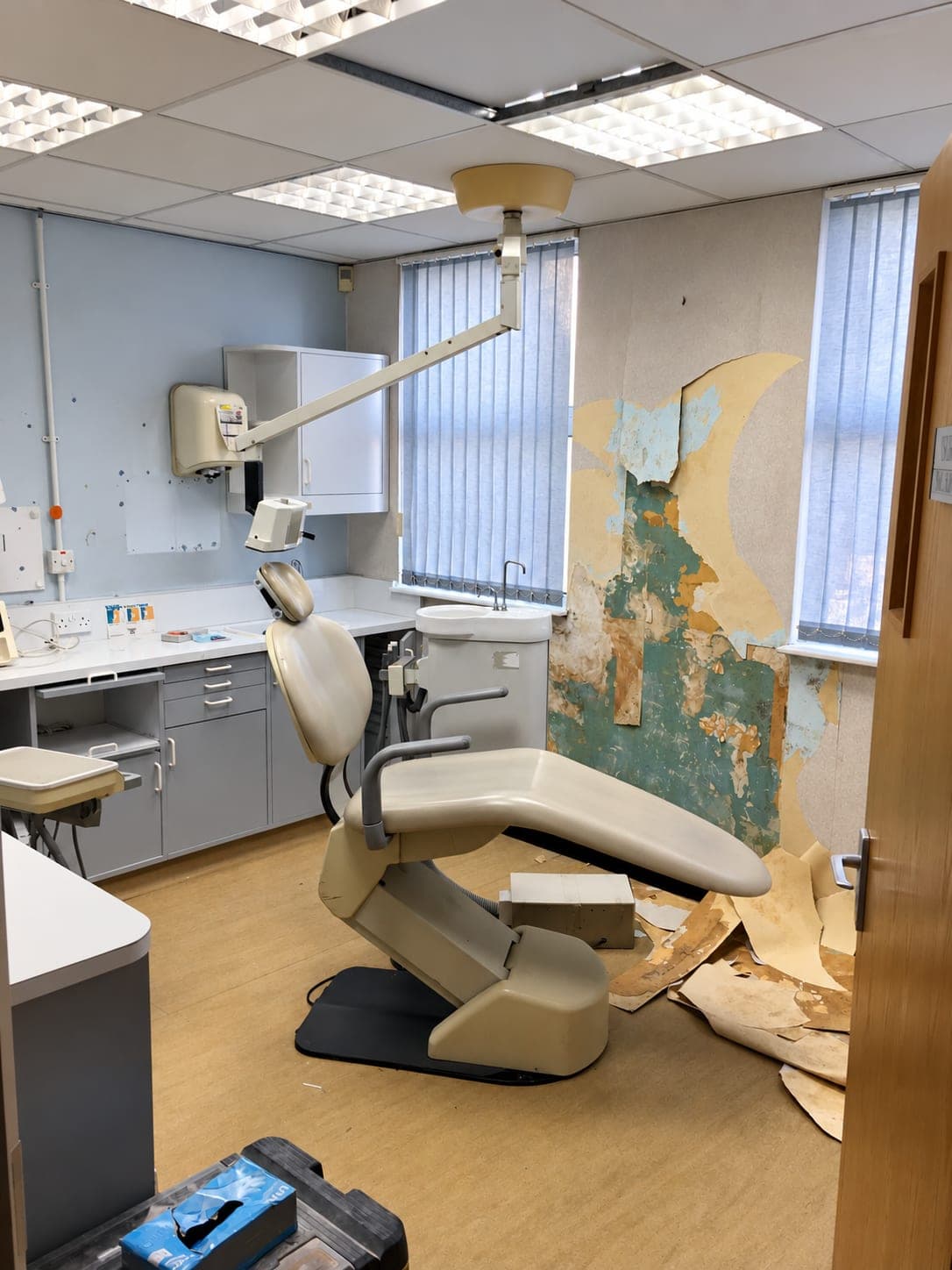 The original surgery before refurbishment, with the old chair and failing wall finishes, Belmont Circle HA3