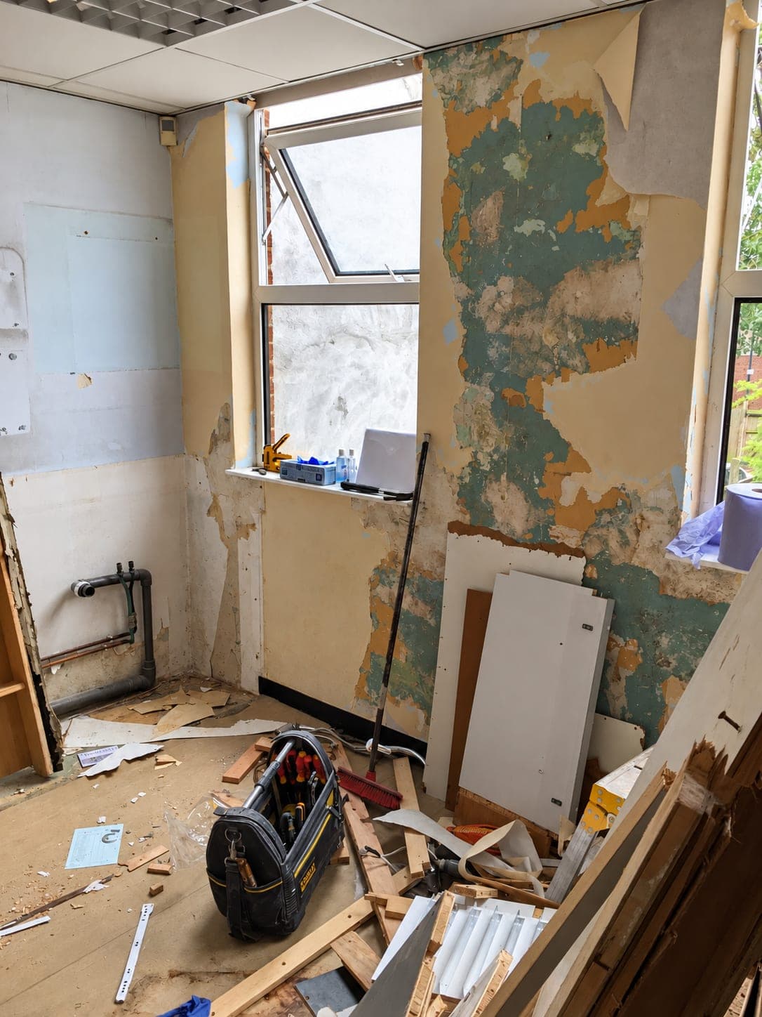 Room stripped out, walls back to bare plaster and old units removed, Belmont Circle HA3