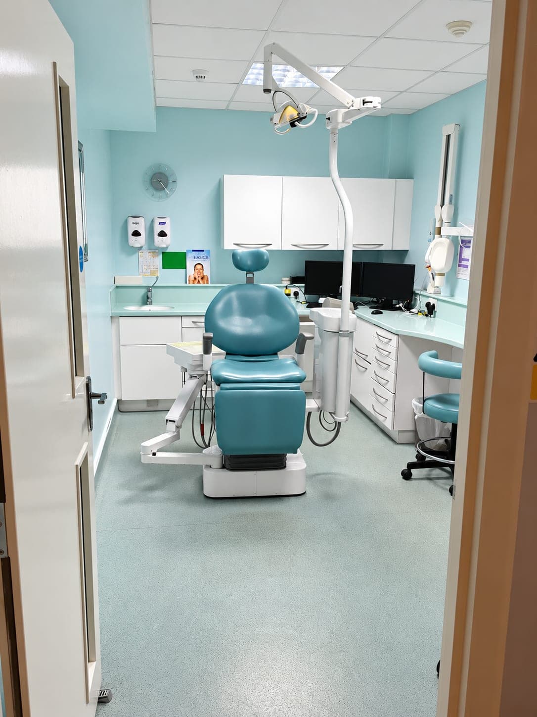 Refurbished dental surgery in duck-egg blue with dental chair and clinical worktop, Bishopsgate EC2