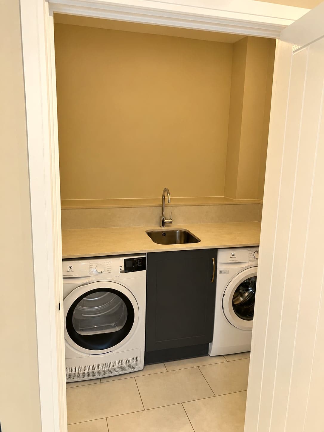 Separate utility room with charcoal units, inset sink and space for washing machine and dryer, North Finchley N12