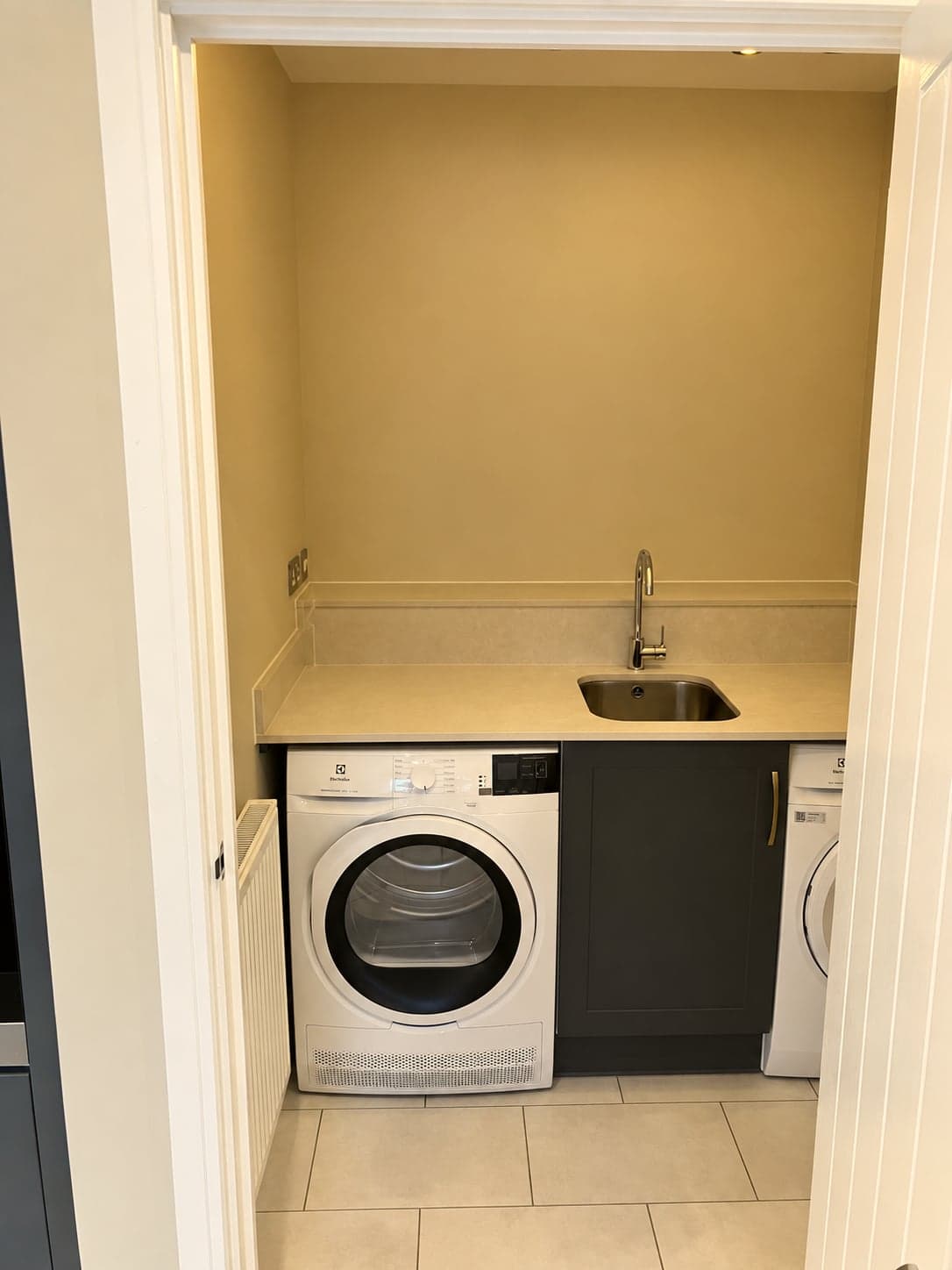 Utility room run with sink, worktop and appliance spaces beneath, North Finchley N12