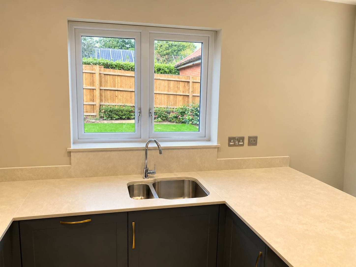 Corner run with inset sink below the window looking onto the garden, North Finchley N12