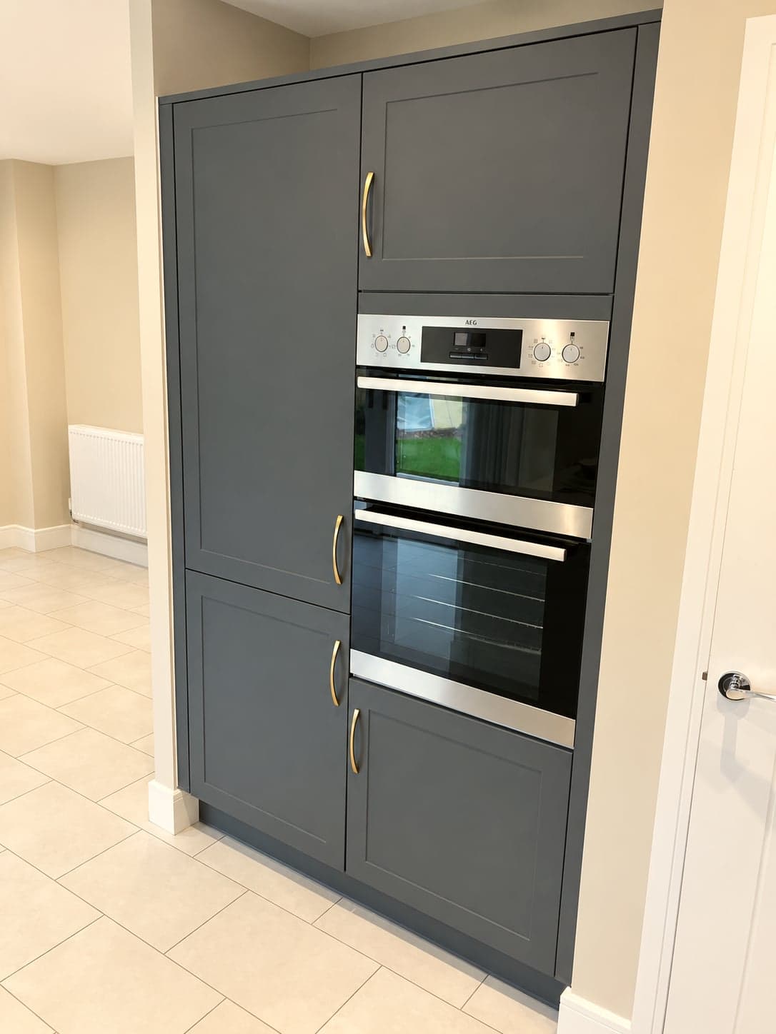 Built-in double oven set into the tall charcoal housing unit, North Finchley N12