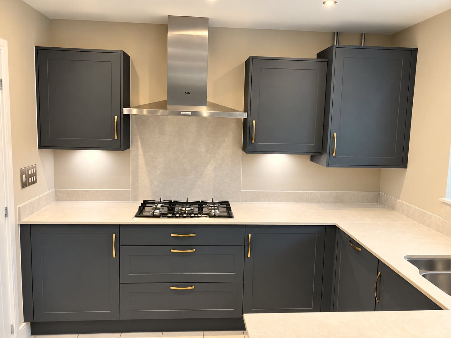Hob run under the chimney extractor with charcoal wall units either side, North Finchley N12