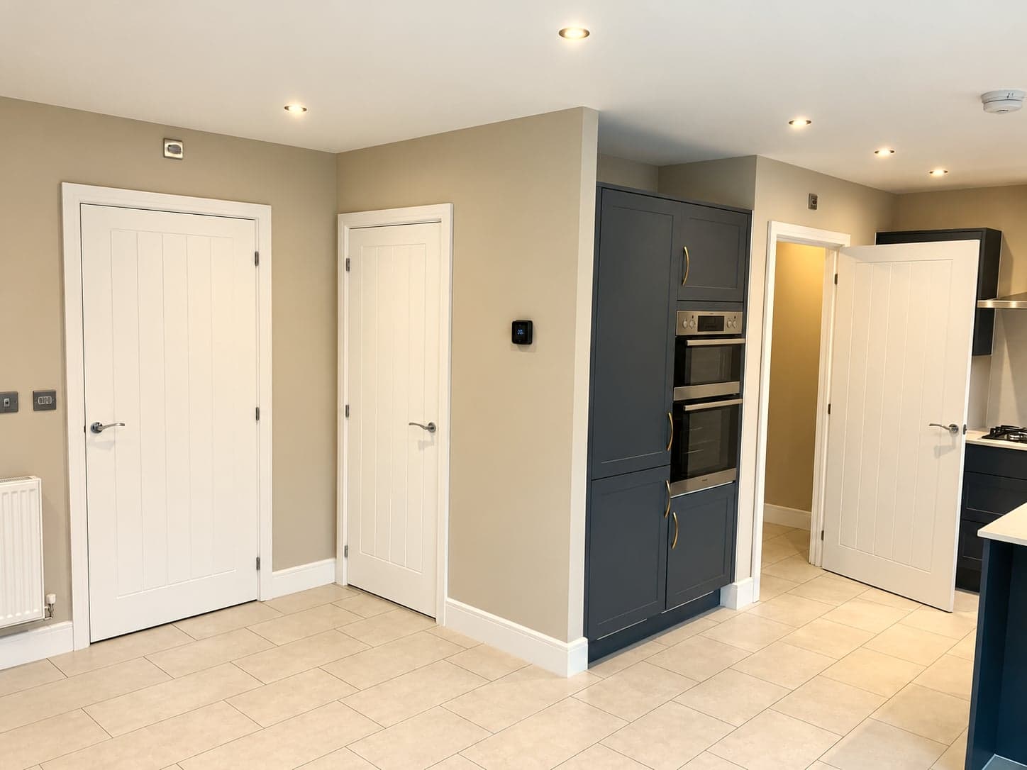 Hall doors with the charcoal oven tower and kitchen beyond, North Finchley N12
