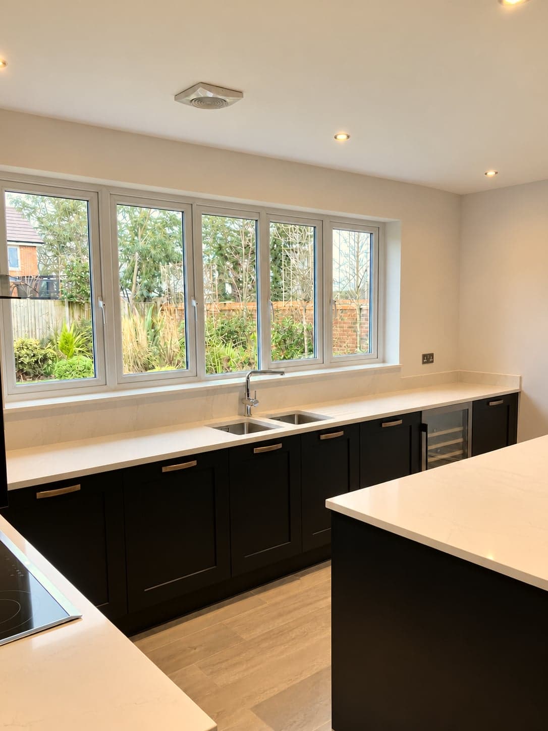 Sink and drainer grooves cut into the quartz below the window, Notting Hill W11