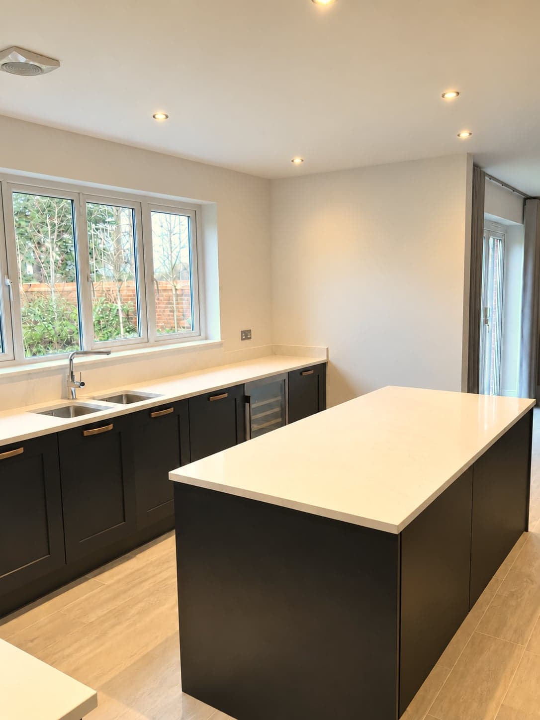 Island and window run with the quartz worktop wrapping the corner, Notting Hill W11