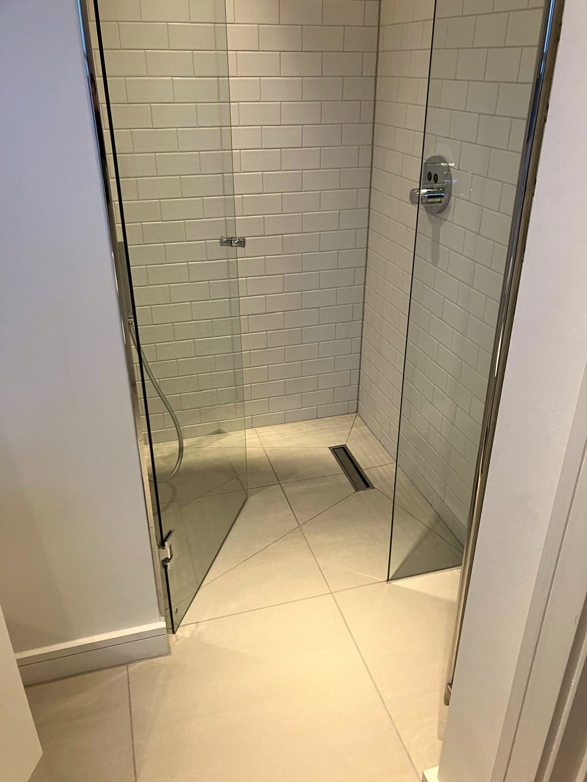 Shower from the doorway showing the linear drain and level tray, Camden NW1