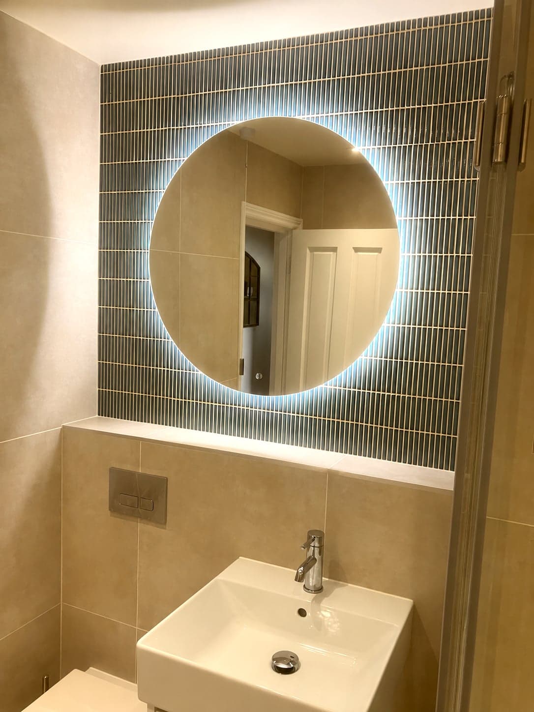 Backlit round mirror with blue mosaic feature tiling and vanity, Streatham Hill SW2