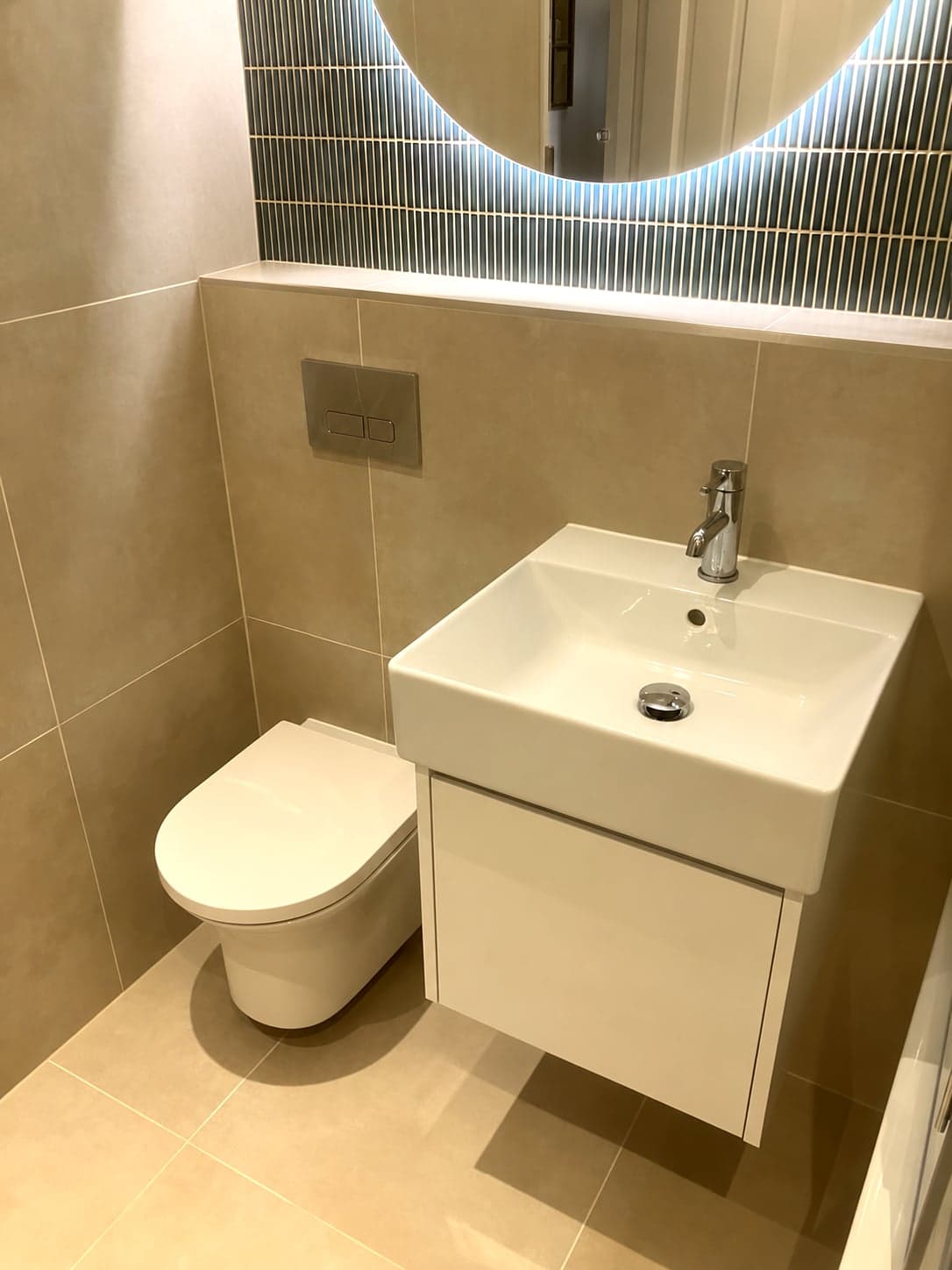 Wall-hung basin unit and WC below the backlit mirror, Streatham Hill SW2