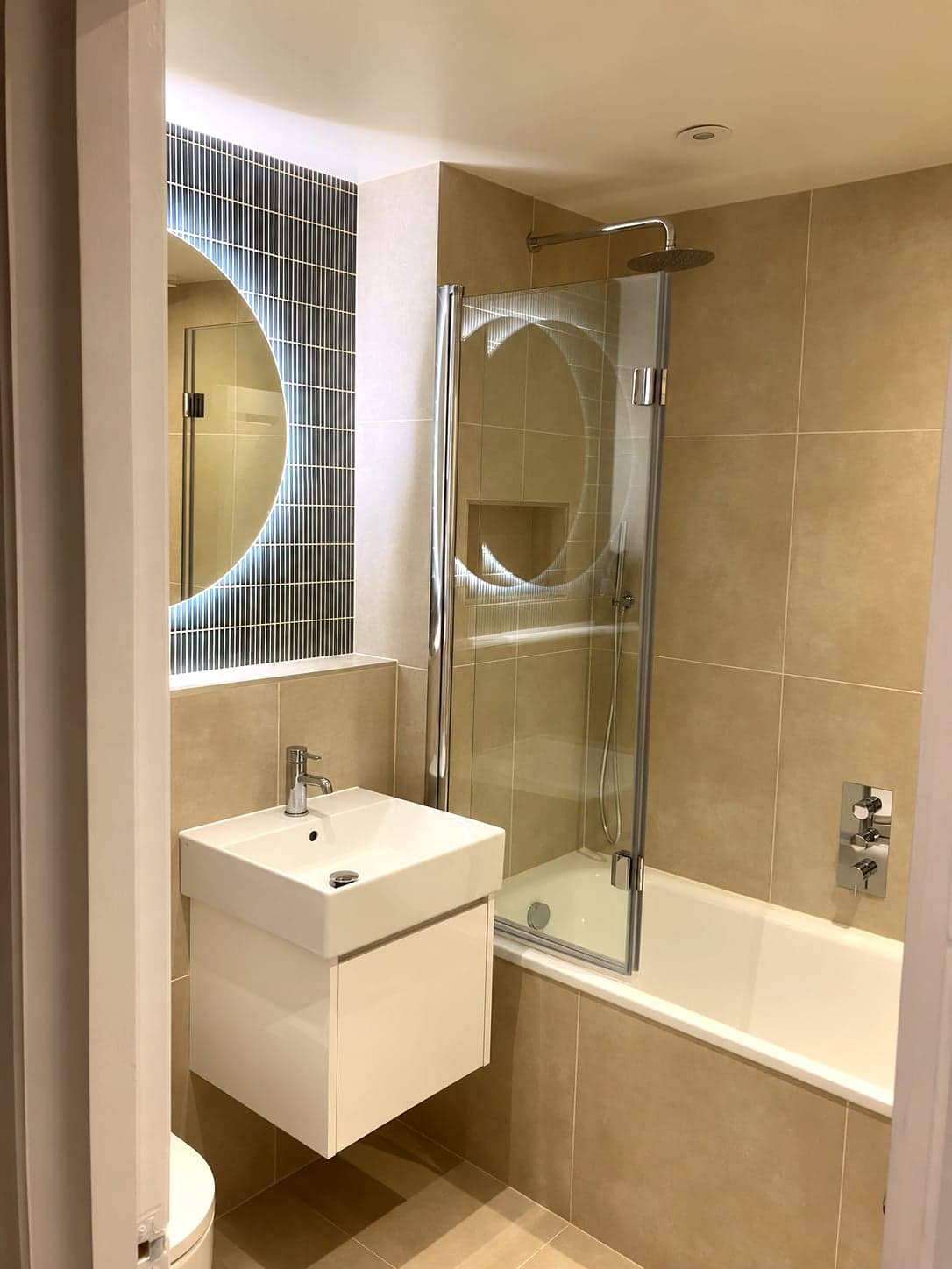 Bathroom from the door: basin, mirror and bath with folding screen, Streatham Hill SW2