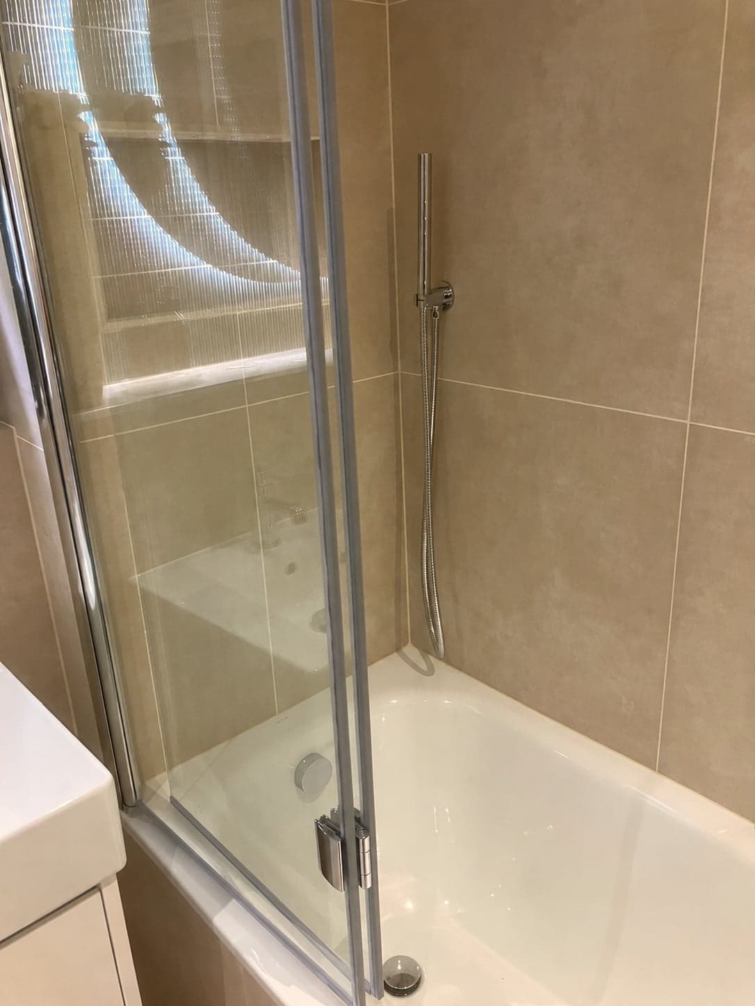 Folding bath screen and shower valve at the end of the bath, Streatham Hill SW2
