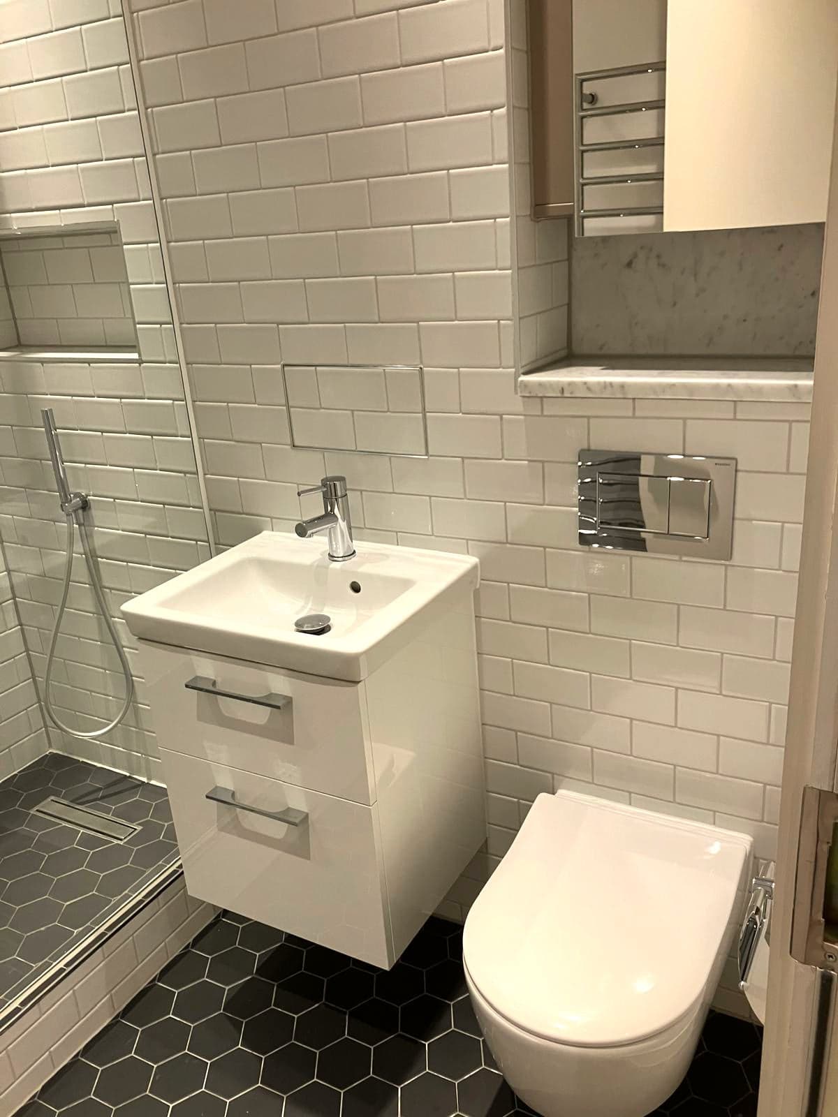 Vanity, WC and heated towel rail with the shower to the left, Marylebone W1