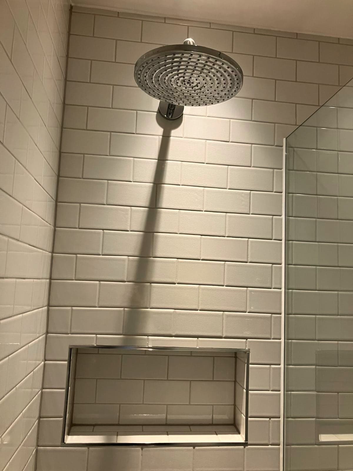 Rainfall shower head and recessed shelf set into the metro tiling, Marylebone W1