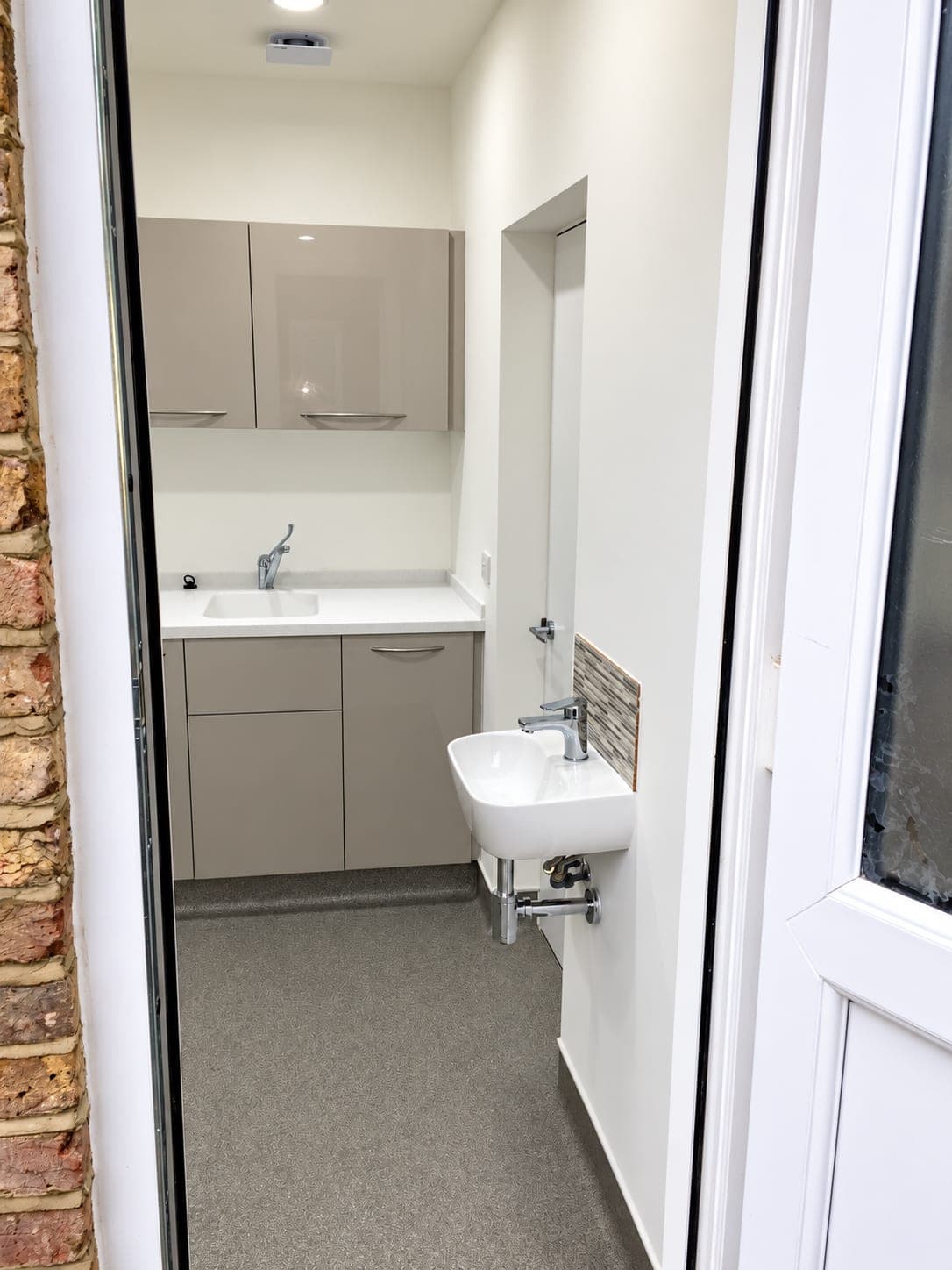 Decontamination room seen from the doorway with the clinical hand basin by the entrance, Chiswick W4