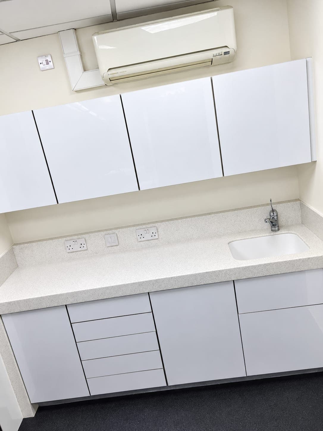 White gloss units, worktop and air conditioning in the finished room, Chiswick W4