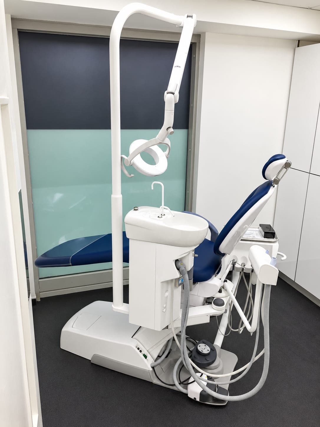 Dental chair and delivery unit beside the blackout blind, Docklands E14