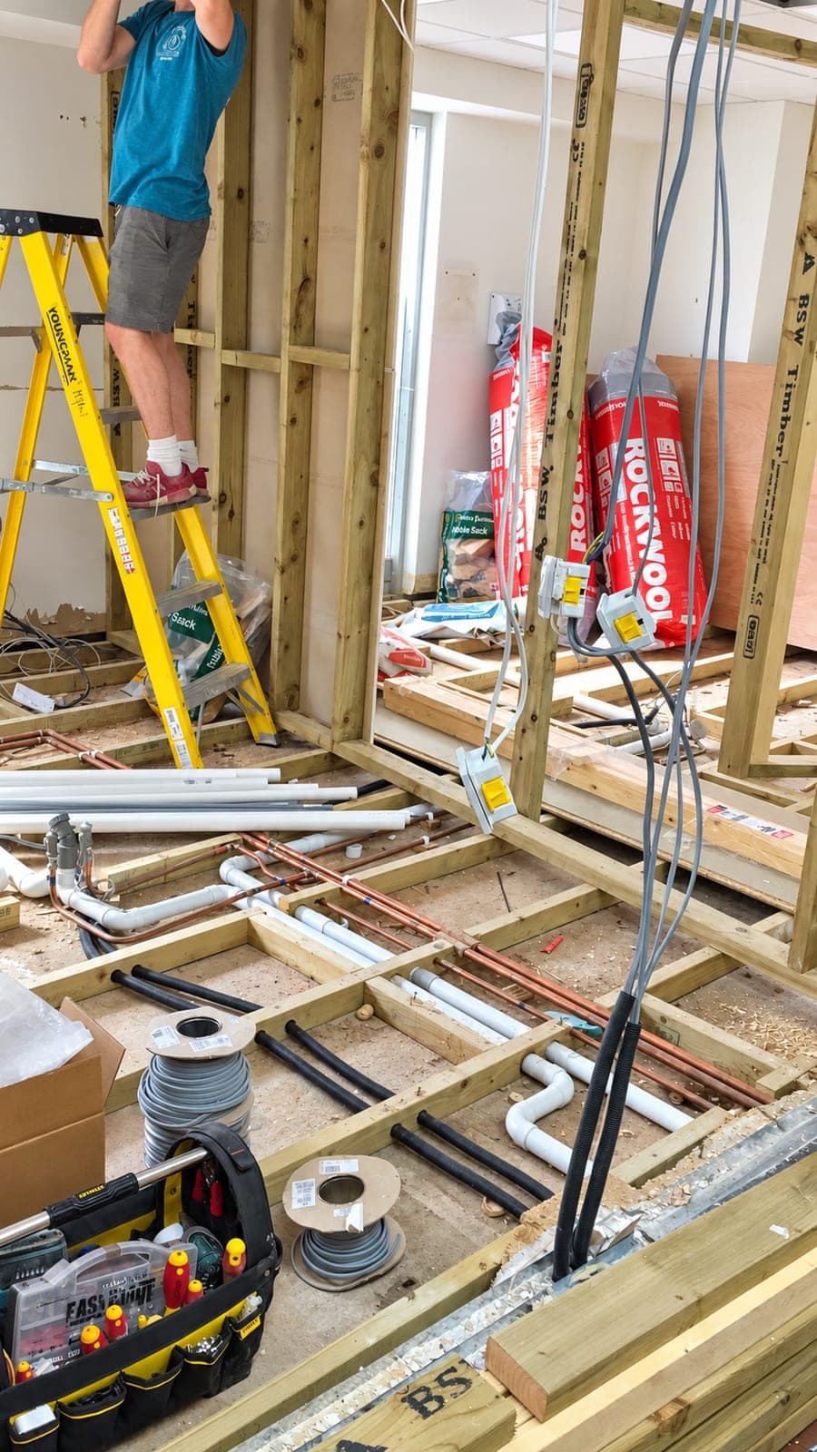 Stud partitions framed out with services dropped in before boarding, Docklands E14