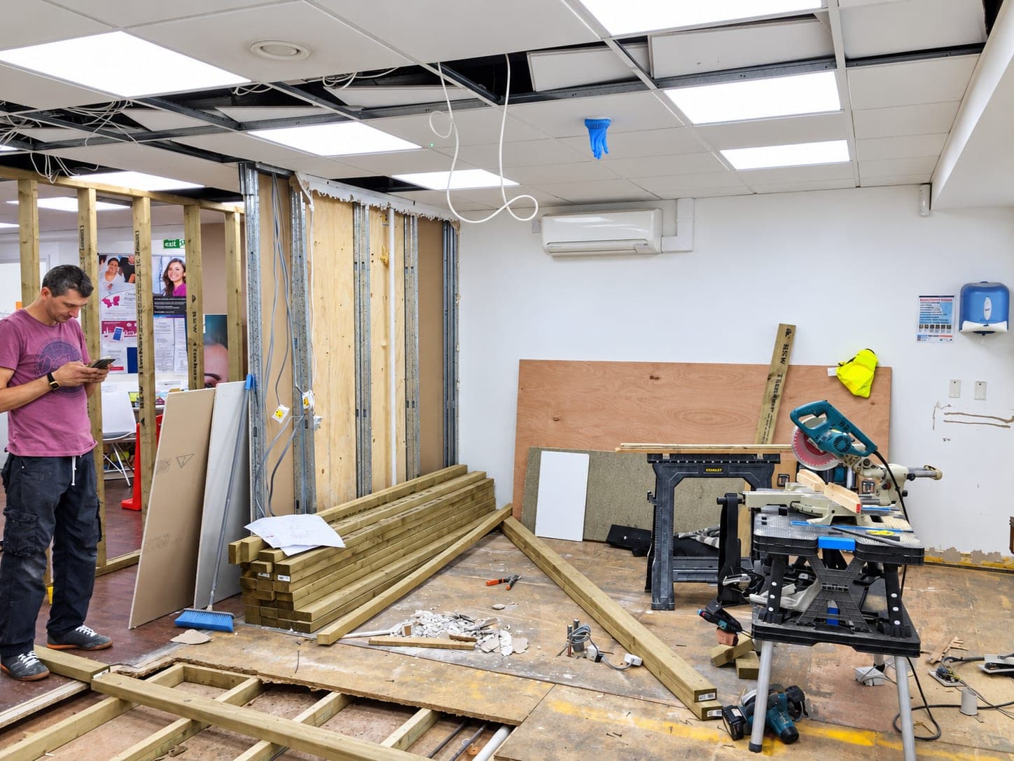 Strip-out stage with the floor lifted and new studwork set out, Docklands E14
