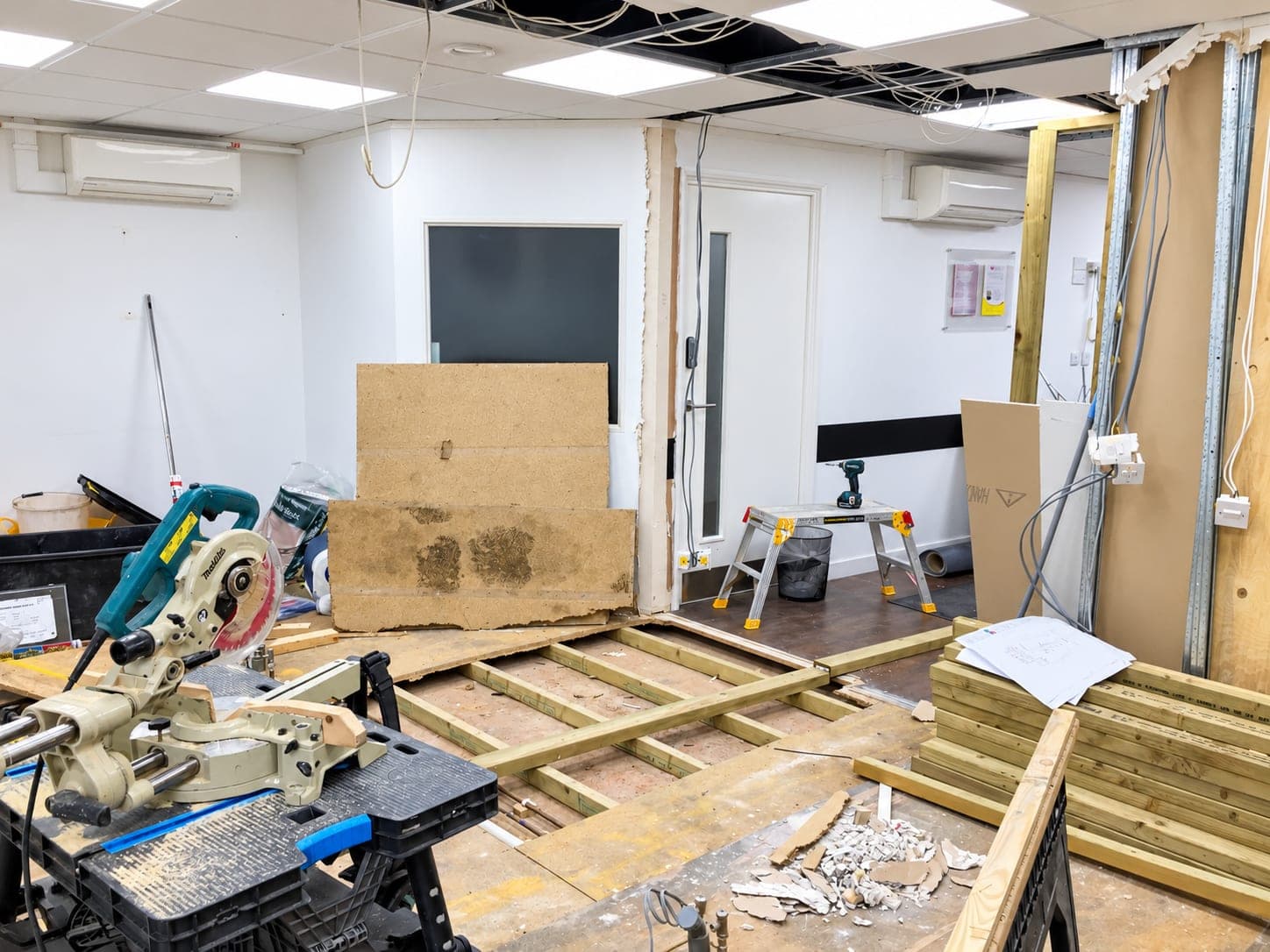 Practice mid-strip-out: floor joists exposed and partitions being formed, Docklands E14