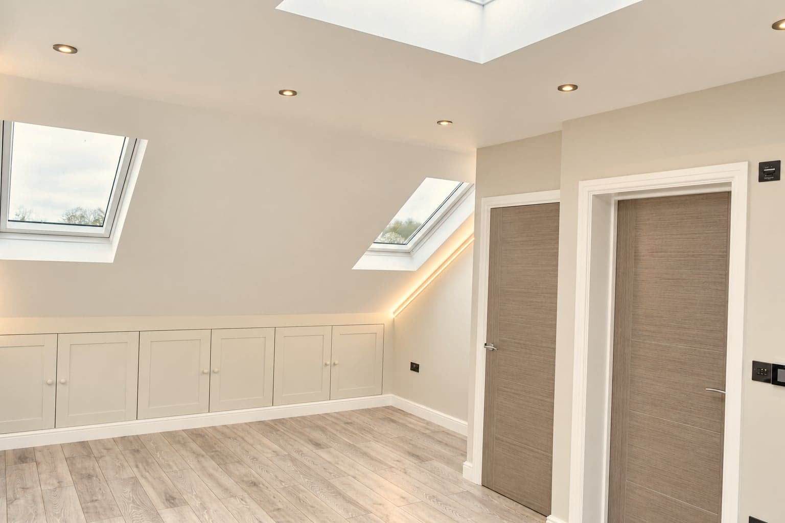 Loft room under the new dormer with twin roof windows and fitted eaves storage along the low wall, Hampstead NW3
