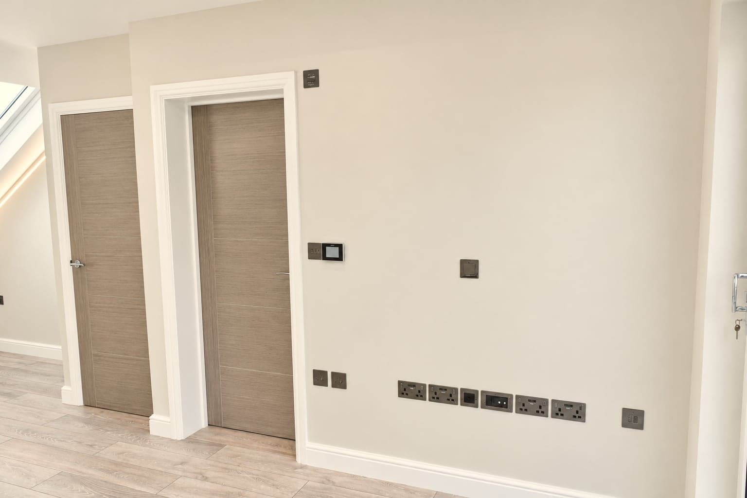 Finished loft wall with door and new sockets, ready for furniture, Hampstead NW3