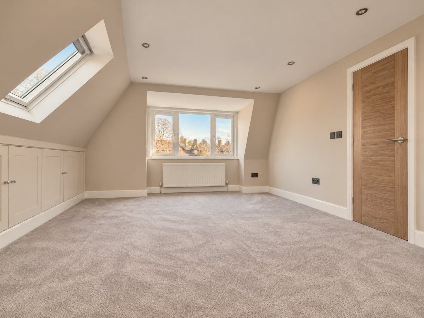 Corner of the loft room showing the dormer window, oak door and eaves cupboards, Rickmansworth WD3