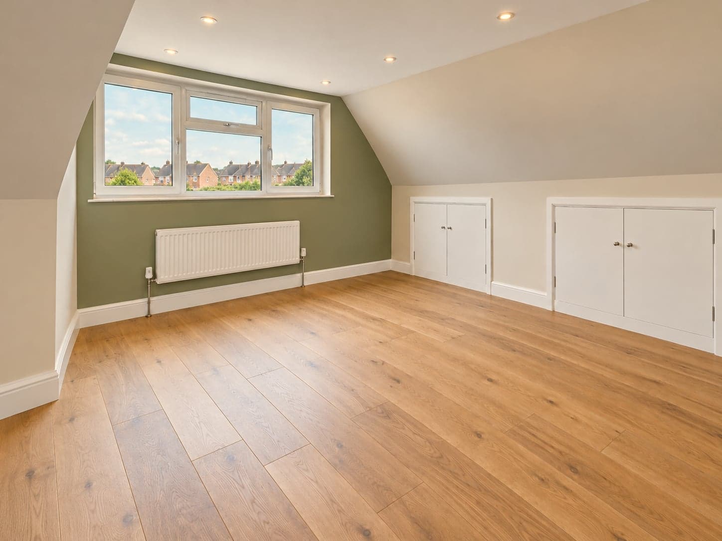 Loft room from the corner showing the dormer window, radiator and run of eaves storage, Watford WD17