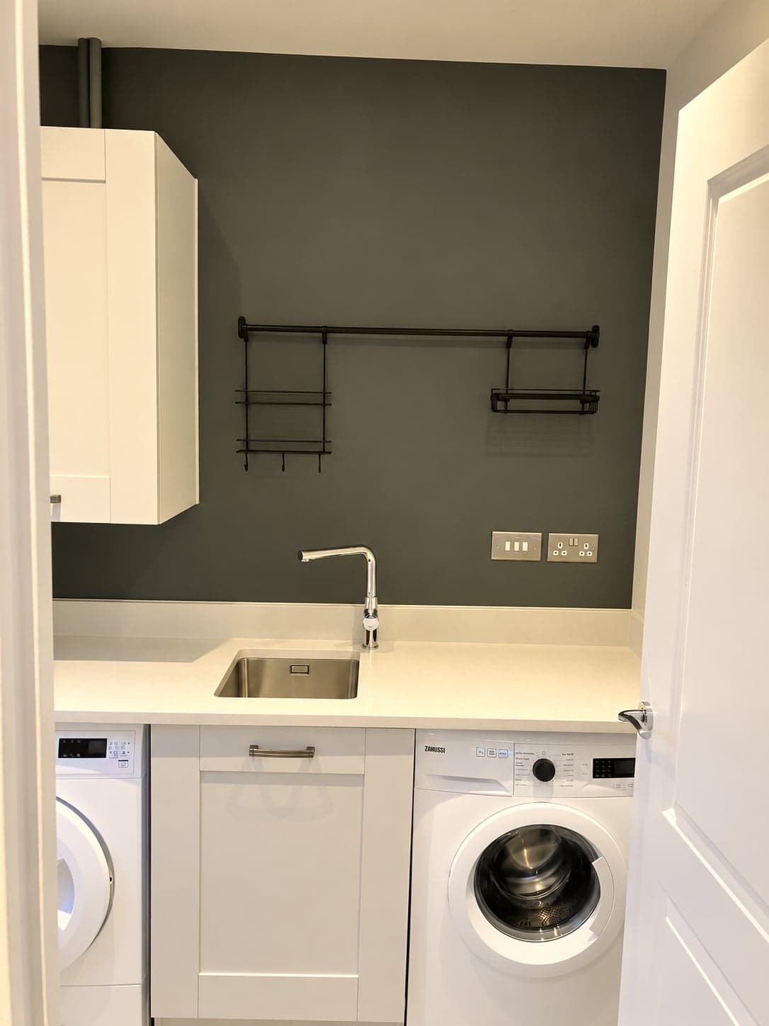 Utility worktop and sink with appliance spaces and open shelving above, Shepherds Bush W12