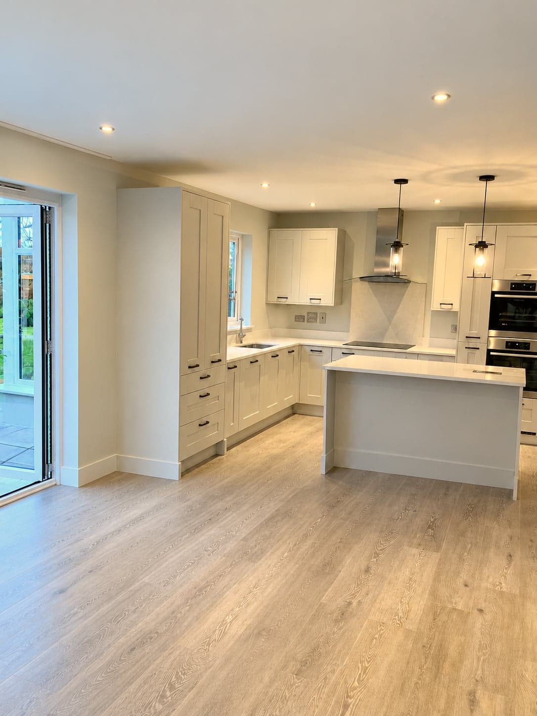 Open-plan kitchen from the garden doors, island and hob run beyond, Shepherds Bush W12