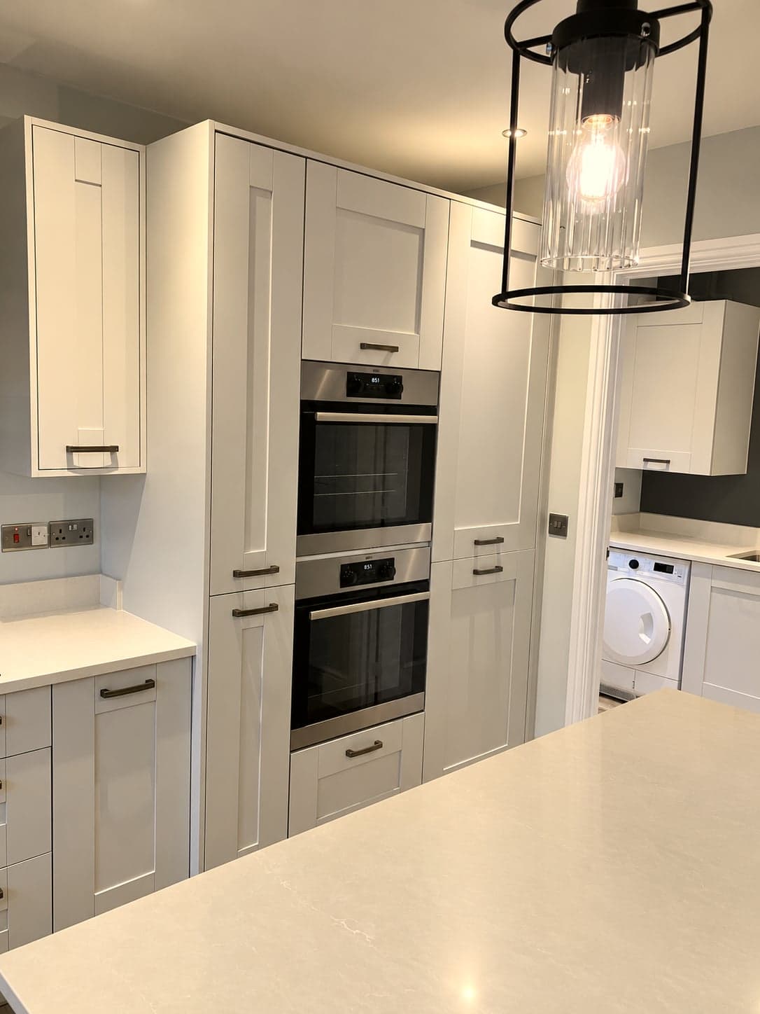Oven tower and tall larder units with the quartz island in front, Shepherds Bush W12