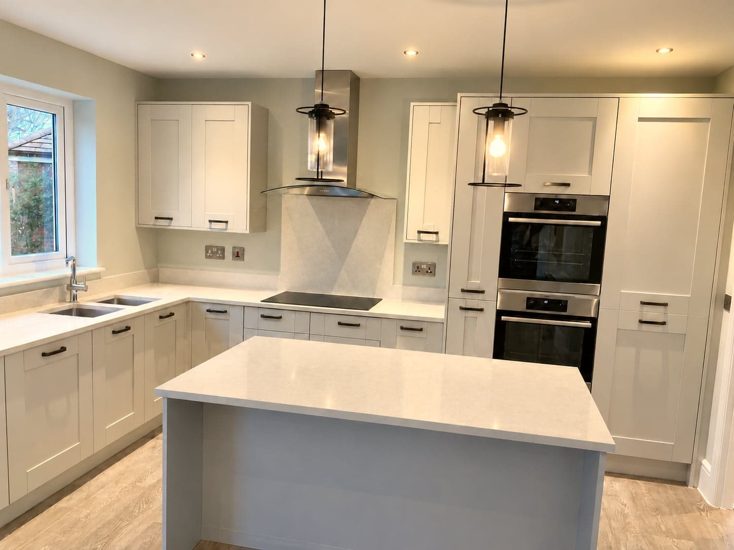 Sink run under the window with induction hob and oven tower opposite, Shepherds Bush W12