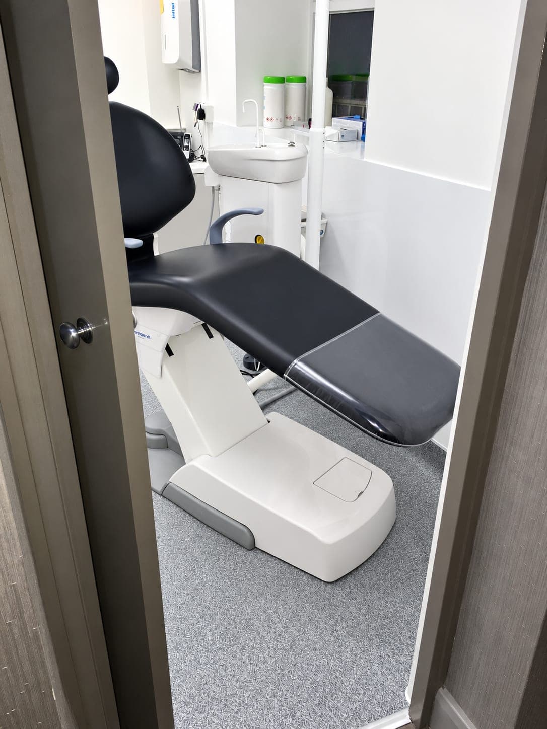 Dental chair and new vinyl flooring seen through the doorway, Finchley N3