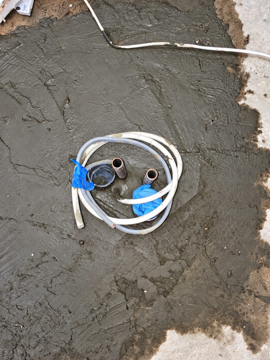 New screed laid over the re-routed suction and services pipework, Finchley N3